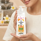 Woman holding a bottle of Golden Girl cleansing milk with a blurred background