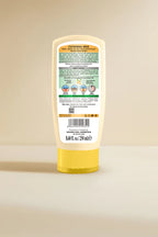 Golden Girl Cleansing Milk bottle with label on a beige background