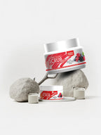 Jar of scrub with berries on a white background