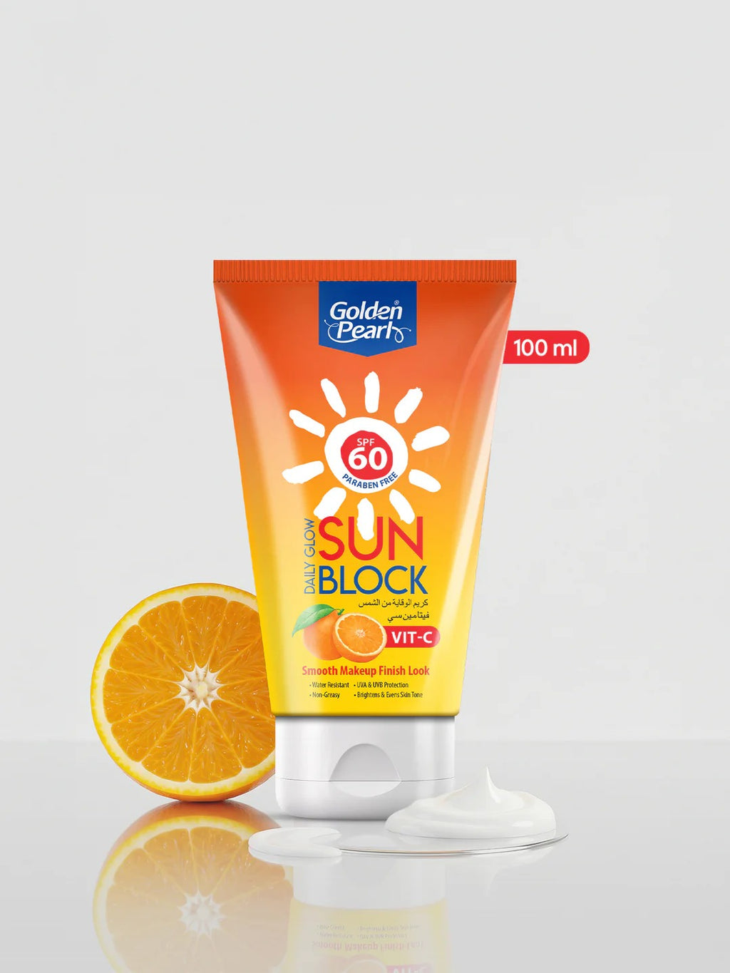 Tube of Golden Pearl sunblock with an orange next to it on a white background