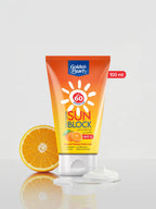 Tube of Golden Pearl sunblock with an orange next to it on a white background