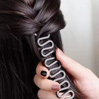 Hair tie being used to manage braided hair