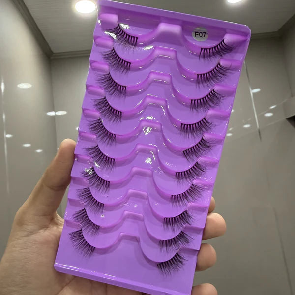 Purple tray with false eyelashes held by a hand in an indoor setting