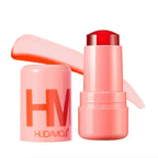 Pink makeup stick with open cap and 'HUDAMOJI' branding on a white background