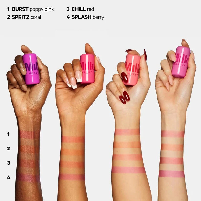 Hands holding pink lip products with color swatches on wrists against a white background