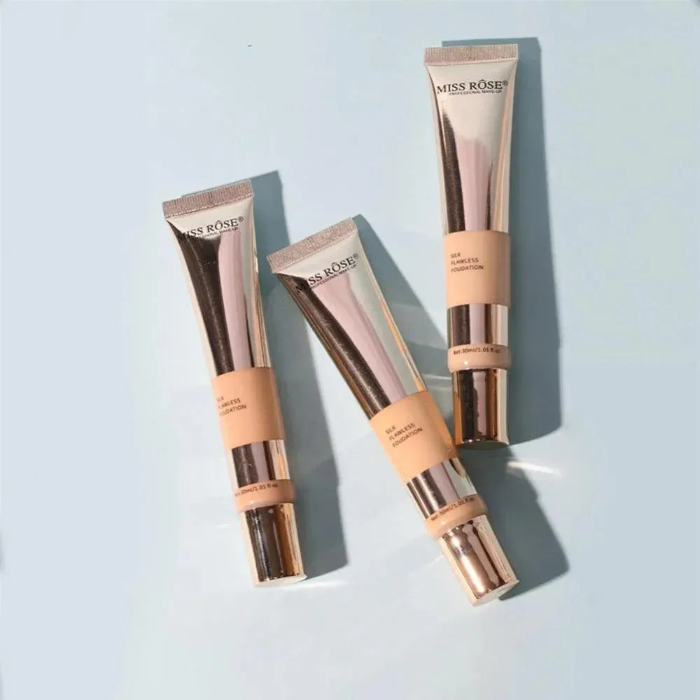Three tubes of Miss Rose foundation on a light blue background
