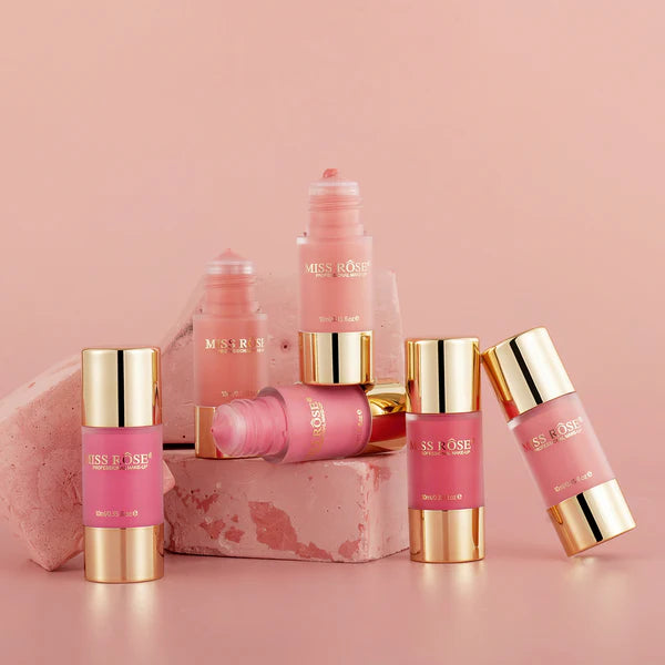 Collection of Miss Rose lip products on a pink background
