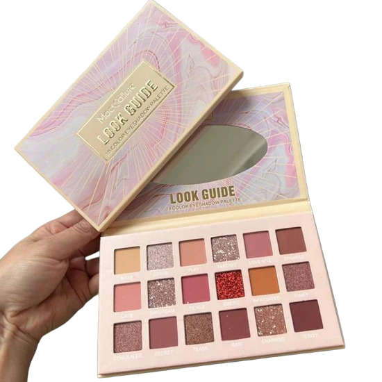 Makeup palette with color swatches held by a hand on a white background