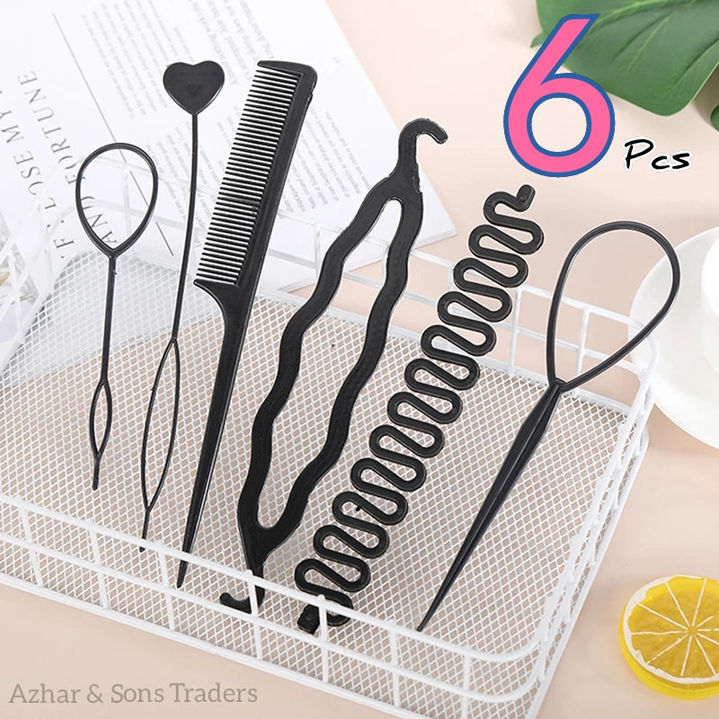 Set of six black hair styling tools on a white tray with a magazine and lemon slice in the background.