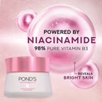 Pond's Bright Beauty cream with pink packaging on a pink background, highlighting niacinamide and vitamin B3.