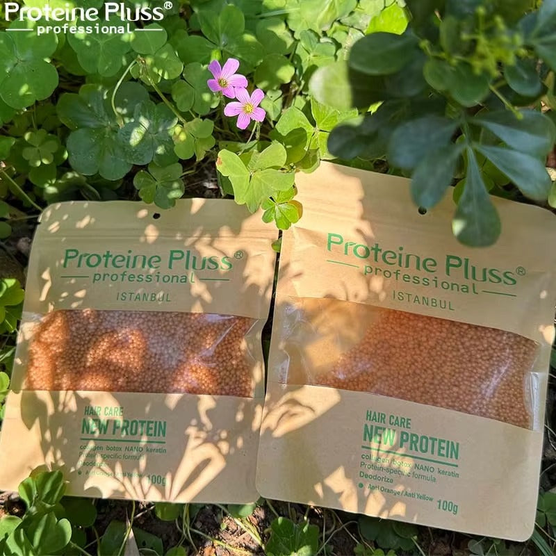 Two packages of Proteine Pluss professional hair care product on a green leafy background