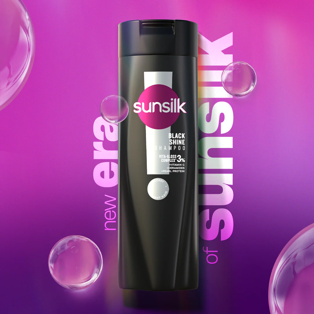 Sunsilk shampoo bottle on a purple background with bubbles