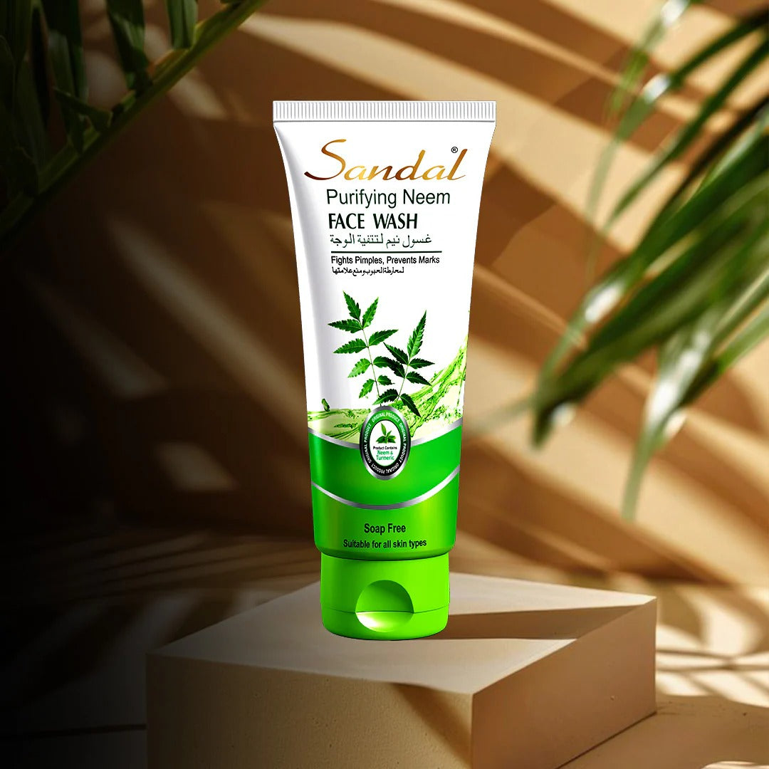 Tube of Sandal Purifying Neem Face Wash with green and white design on a beige platform with plant shadows.