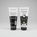 Two bottles of skin.BIOTICS Goat Milk Brightening Face Wash on a gray background