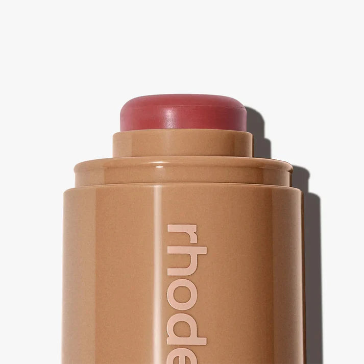Cosmetic stick with 'rhode' branding on a white background