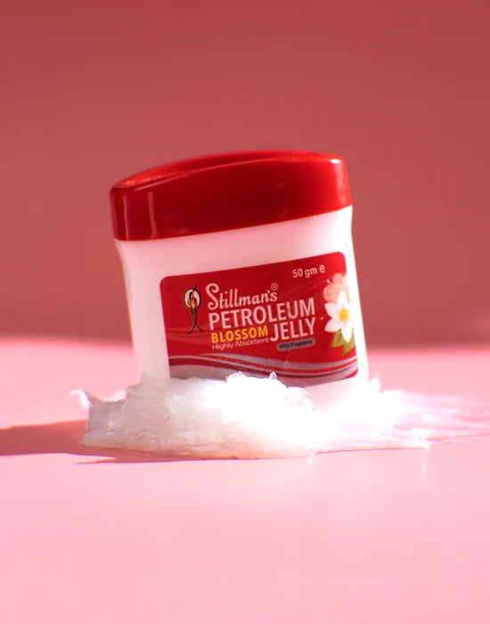 Jar of Stillman's Petroleum Blossom Jelly on a pink background