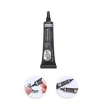 Lash glue tube with applicator on a white background