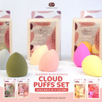 Set of colorful cloud puffs with packaging in the background on a white surface.
