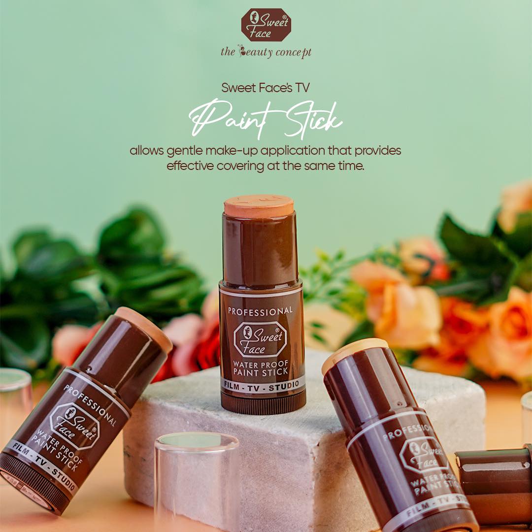 Three 'Sweet Face' paint sticks on a decorative stand with a blurred floral background