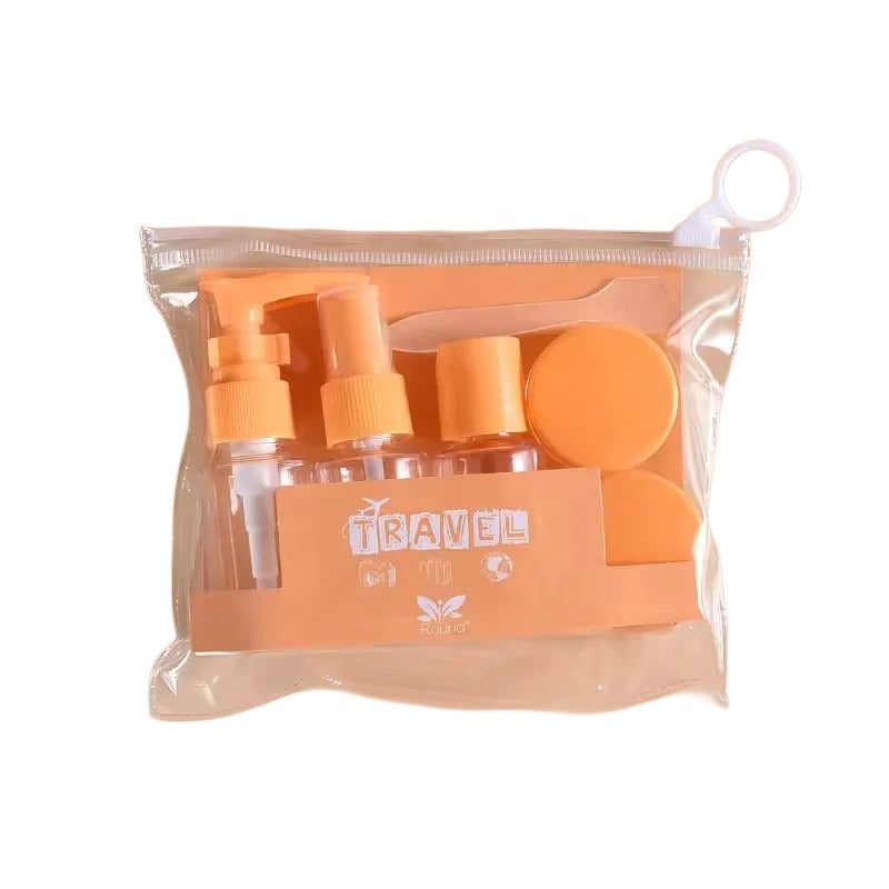 Set of travel-sized bottles with orange caps in a clear bag labeled 'Travel' on a white background.