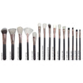 Set of makeup brushes with black handles and white bristles on a white background