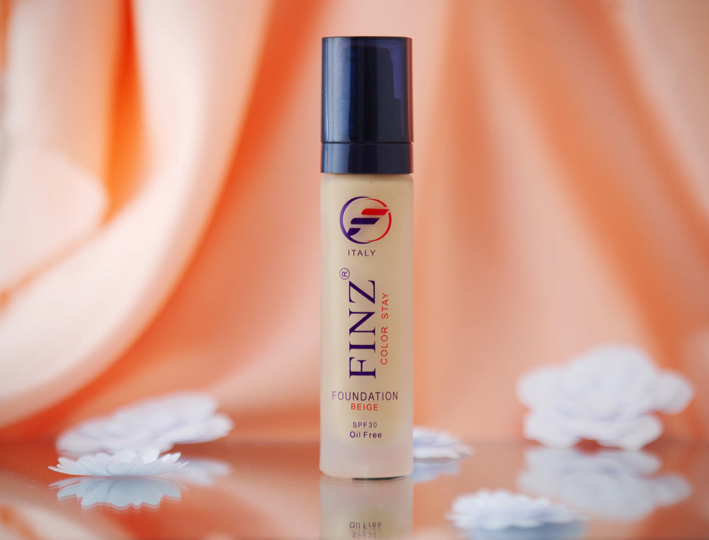 Finz Color Stay Oil Free Liquid Foundation SPF 30 bottle with visible brand logo on a reflective surface with a blurred background