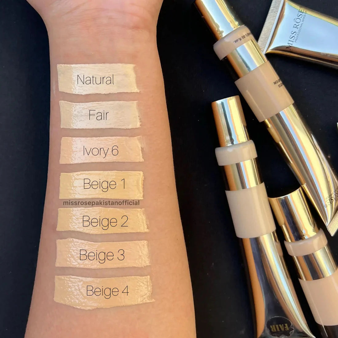 Makeup swatches on a wrist with 'Miss Rose' product packaging in the background