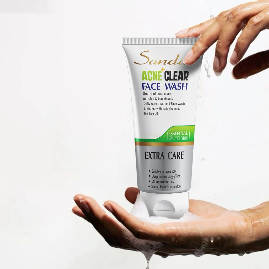 Tube of Sandal Acne Clear Face Wash being held with a hand on a white background